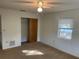 Bedroom with carpet, ceiling fan, and a closet at 11556 Linden Dr, Spring Hill, FL 34608