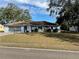 Ranch-style home with paved driveway and mature landscaping at 11556 Linden Dr, Spring Hill, FL 34608