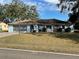 Ranch-style home with paved driveway and mature landscaping at 11556 Linden Dr, Spring Hill, FL 34608