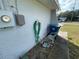 Exterior wall with hose, meter, and recycling bin at 11556 Linden Dr, Spring Hill, FL 34608