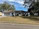 Ranch-style home with paved driveway and mature landscaping at 11556 Linden Dr, Spring Hill, FL 34608