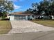 Ranch-style home with paved driveway and mature landscaping at 11556 Linden Dr, Spring Hill, FL 34608