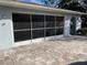 House exterior featuring a large garage with paver driveway at 11556 Linden Dr, Spring Hill, FL 34608