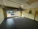 Spacious garage with carpet flooring and automatic door at 11556 Linden Dr, Spring Hill, FL 34608