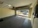 Spacious garage with carpet flooring and automatic door at 11556 Linden Dr, Spring Hill, FL 34608