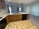 Kitchen with wood cabinets, tiled floor, and appliances at 11556 Linden Dr, Spring Hill, FL 34608