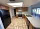 Kitchen with black appliances and wood cabinets at 11556 Linden Dr, Spring Hill, FL 34608