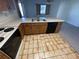 Kitchen with wood cabinets, tiled floor, and appliances at 11556 Linden Dr, Spring Hill, FL 34608