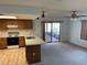 Kitchen with wood cabinets, an island, and access to a patio at 11556 Linden Dr, Spring Hill, FL 34608