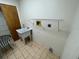 Laundry room with utility sink and shelving at 11556 Linden Dr, Spring Hill, FL 34608