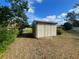 Exterior view of a light beige storage shed at 11556 Linden Dr, Spring Hill, FL 34608