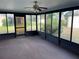 Bright sunroom with ceiling fan and view of backyard at 11556 Linden Dr, Spring Hill, FL 34608