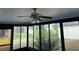 Bright sunroom with ceiling fan and view of backyard at 11556 Linden Dr, Spring Hill, FL 34608