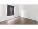 Simple bedroom with grey curtains and wood-look flooring at 13065 Conquistador Loop, Spring Hill, FL 34610