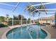 Kidney-shaped screened pool with a relaxing atmosphere at 13235 Legends Trl, Dade City, FL 33525