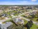 Aerial view of a residential neighborhood with lush landscaping and various house styles at 14101 Andrew Scott Rd, Spring Hill, FL 34609