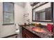 Bathroom with dark vanity, granite countertop, and copper sink at 14101 Andrew Scott Rd, Spring Hill, FL 34609