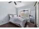 Well lit bedroom with a large window and wood floor at 14101 Andrew Scott Rd, Spring Hill, FL 34609