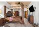 Main bedroom with a large four poster bed and ensuite at 14101 Andrew Scott Rd, Spring Hill, FL 34609