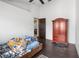 Bedroom with wood floors and a large wardrobe at 14101 Andrew Scott Rd, Spring Hill, FL 34609