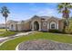 House exterior showcasing a tan two-story house with landscaping at 14101 Andrew Scott Rd, Spring Hill, FL 34609
