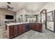 Open kitchen with island, granite counters, and dark wood cabinets at 14101 Andrew Scott Rd, Spring Hill, FL 34609