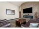 Living room featuring a stone fireplace and large screen TV at 14101 Andrew Scott Rd, Spring Hill, FL 34609