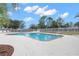Inviting community pool with surrounding lounge chairs and playground nearby at 14101 Andrew Scott Rd, Spring Hill, FL 34609