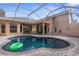 Relaxing kidney-shaped pool with a patio and covered lanai at 14101 Andrew Scott Rd, Spring Hill, FL 34609
