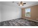 Simple bedroom with wood-look flooring and a ceiling fan at 16076 Narrow St, Spring Hill, FL 34604