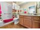 Guest bathroom with a shower/tub combo, single vanity, and wood-look tile flooring at 1608 Morning Rose Pl, Trinity, FL 34655