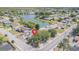 Aerial view highlighting the property's location near a lake and residential area at 3049 Moog Rd, Holiday, FL 34691