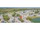 Aerial view showcasing the home's setting amongst other houses and a lake at 3049 Moog Rd, Holiday, FL 34691