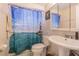 Bathroom with white sink, toilet, and ocean-themed shower curtain at 3049 Moog Rd, Holiday, FL 34691