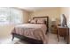 Bedroom with double bed, nightstands, and window with blinds at 3049 Moog Rd, Holiday, FL 34691