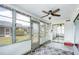 Bright sunroom features ceiling fan, stylish rug, and ample natural light at 4209 Prince Pl # A, New Port Richey, FL 34652