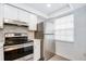 Modern kitchen with stainless steel appliances and white cabinets at 4209 Prince Pl # A, New Port Richey, FL 34652