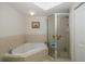 Bathroom with corner tub, shower, and a single vanity at 4516 Seagull Dr # 413, New Port Richey, FL 34652