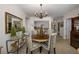Bright dining room features a round table and chairs, and chandelier at 4516 Seagull Dr # 413, New Port Richey, FL 34652