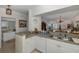 Kitchen with white cabinets, granite counters, and breakfast bar at 4516 Seagull Dr # 413, New Port Richey, FL 34652