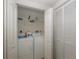 Well-lit laundry room with washer, dryer, and shelving at 4516 Seagull Dr # 413, New Port Richey, FL 34652