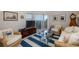 Coastal-themed living room with wicker furniture and blue striped rug at 4516 Seagull Dr # 413, New Port Richey, FL 34652