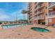 Community pool and spa with lounge chairs at 4516 Seagull Dr # 413, New Port Richey, FL 34652
