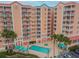 Inviting community pool with lounge chairs and umbrellas at 4516 Seagull Dr # 413, New Port Richey, FL 34652