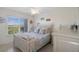 Bedroom with full-size bed, coastal decor and natural light at 4550 Bay Blvd # 1237, Port Richey, FL 34668