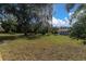 Spacious backyard with lush lawn and mature trees at 4635 Bellemede Blvd, New Port Richey, FL 34655