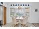 Cozy dining area with a table and four chairs, overlooking the backyard at 4635 Bellemede Blvd, New Port Richey, FL 34655
