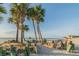 Scenic beach with palm trees, a bench, and tranquil views of the ocean at 4942 Hazner St, New Port Richey, FL 34652