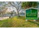 Gulf Harbors Beach Club entrance sign with lush landscaping and a peek of the beach at 4942 Hazner St, New Port Richey, FL 34652