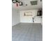 Garage with tiled floor, shelving, and a water heater at 4942 Hazner St, New Port Richey, FL 34652